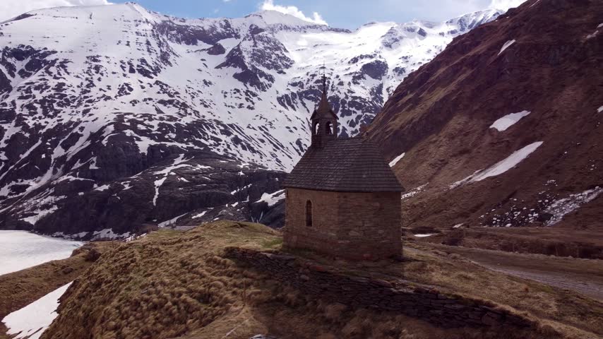 Drone orbit around a mountain chapel on the Grossglockner High Alpine Road, Austria	
