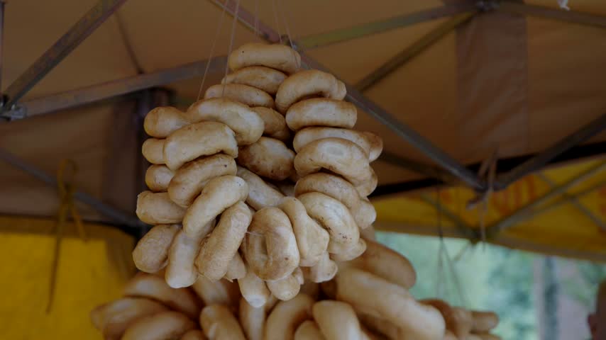 Traditional Polish pretzels hanging at a market stall during a local outdoor fair
