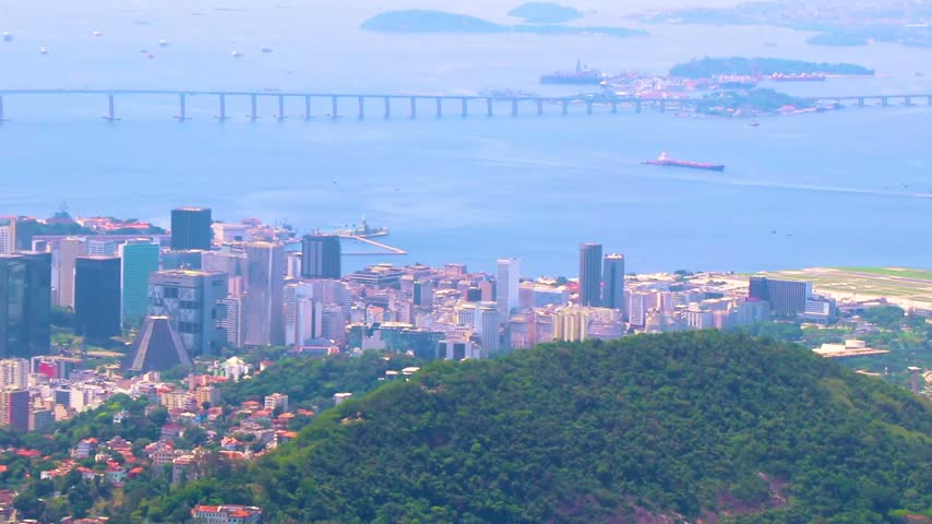 Panoramic view across Rio de Janeiro city center toward the Niteroi Bridge, with ocean, beaches and coastal scenery stretching across the urban landscape in Rio de Janeiro State of Rio de Janeiro Brazil.