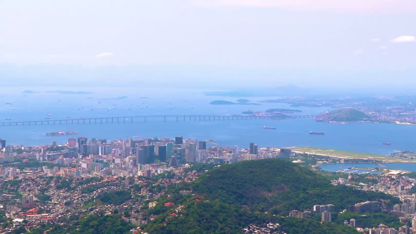 Panoramic view across Rio de Janeiro city center toward the Niteroi Bridge, with ocean, beaches and coastal scenery stretching across the urban landscape in Rio de Janeiro State of Rio de Janeiro Brazil.