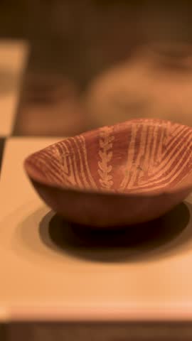 Close-up of an ancient decorated clay pottery bowl in the Egyptian Museum in Turin, Italy.