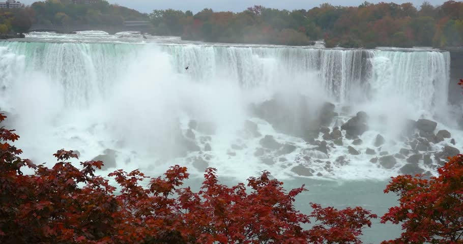 Bridal Veil Falls framed by red autumn foliage at Niagara Falls