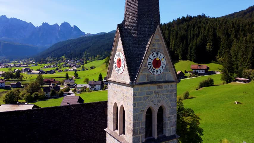 Pfarrkirche Gosau church tower and clock with Austrian Alps in background, Austria	