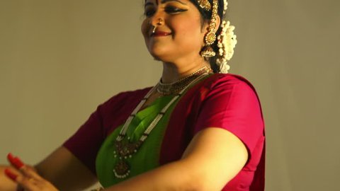 A lovely young woman storytelling with mudra or hand gestures traditional to classical Indian dance.
