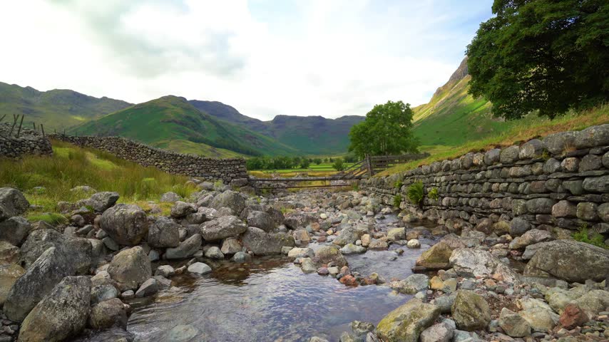 Mountain stream flowing into mountain valley