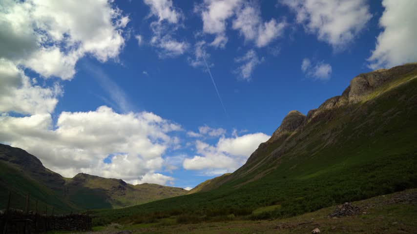 Big blue mountain sky with aeroplane trail