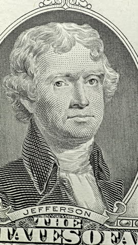 Thomas Jefferson bill moves from neutral engraving to bright green under scanning light. Banknote portrait gradually returns to its original pale appearance.