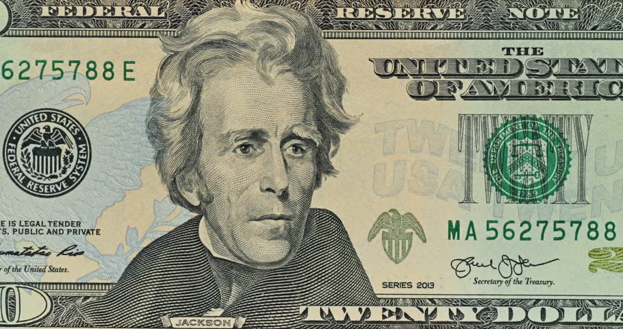 Andrew Jackson appears on twenty dollar bill as green light travels down from above. Slow sweep washes over engraved portrait and printed currency details.