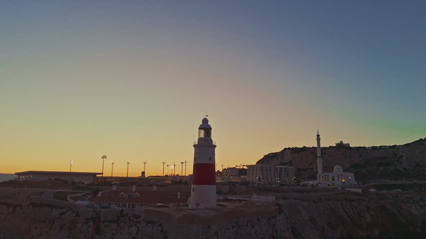 Aerial view of Europa Point lighthouse at sunset with the Ibrahim-al-Ibrahim Mosque in the background, Gibraltar, Gibraltar.