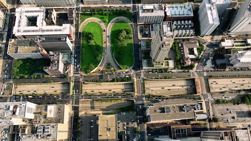 A striking vertical top-down drone shot looking straight down onto a complex highway interchange and urban cityscape in Center City, Philadelphia. 