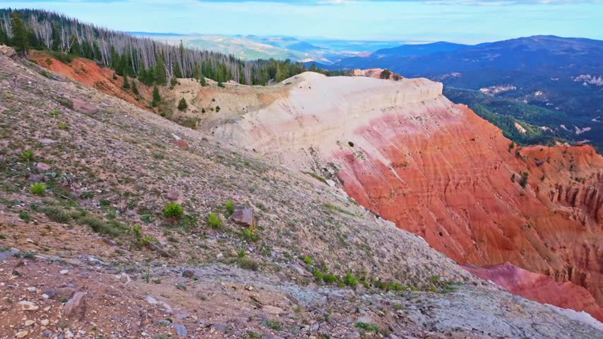 Golden sunrise light glows over the amphitheater formations at Spectra Point along the Ramparts Overlook Trail in Cedar Breaks National Monument