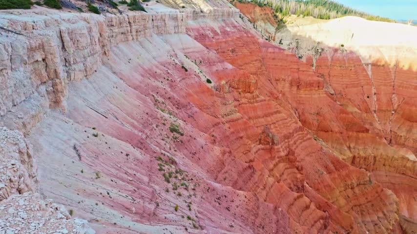 Golden sunrise light glows over the amphitheater formations at Spectra Point along the Ramparts Overlook Trail in Cedar Breaks National Monument