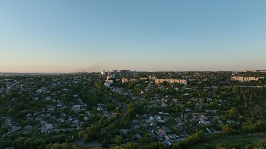 Mixed residential neighborhoods with detached houses and apartment blocks in a drone aerial view. Urban planning, real estate and neighborhood transport infrastructure.