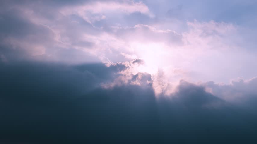 Bright sunlight shining through dramatic clouds and dark blue sky during the afternoon in Tainan, Taiwan.