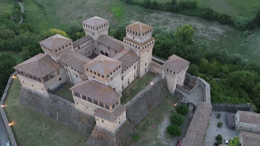 Torrechiara Castle aerial view of 15th century Italian fortress at sunset epic monument to power and eternal love story cinematic camera movement Parma region
