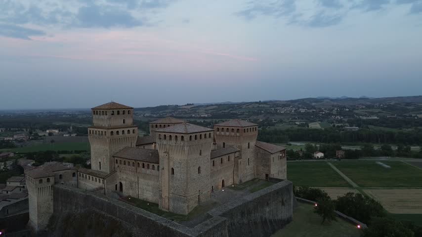 Torrechiara Castle aerial view of 15th century Italian fortress at sunset epic monument to power and eternal love story cinematic camera movement Parma region