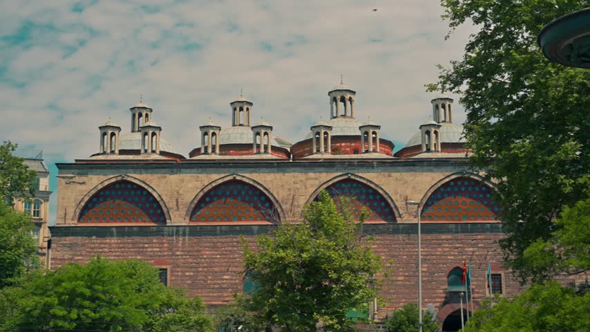 Historic Ottoman brick building with arched windows and rooftop chimneys in Istanbul, Turkey