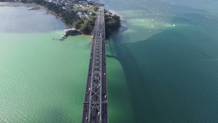 Spectacular overhead drone shot of the Auckland Harbour Bridge in New Zealand.
