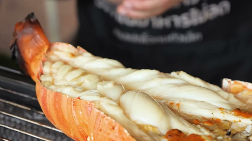 A detailed, high-quality close-up shot of a freshly cooked lobster that has been split in half.