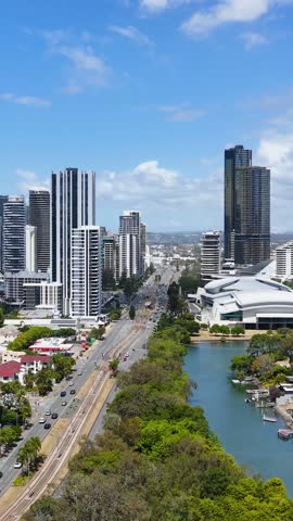 High angle aerial perspective of modern skyscrapers, roadways, and waterways in Gold Coast, Australia.