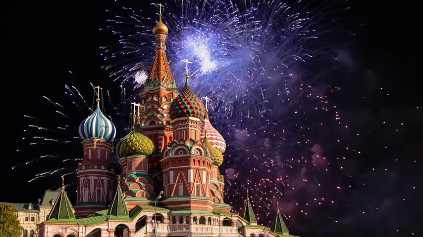Temple of Basil the Blessed and fireworks in honor of Victory Day celebration (WWII), Red Square, Moscow, Russia. Time lapse, with zoom