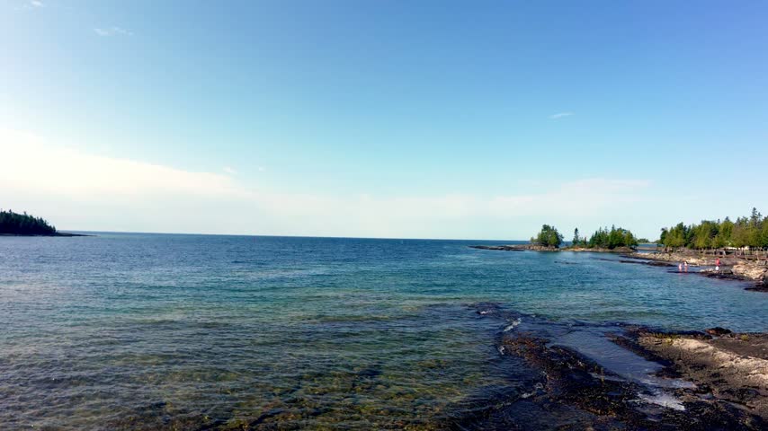 Static shot of gentle water lapping on rocky beach at sunset, Manitoulin Island, Northern Ontario