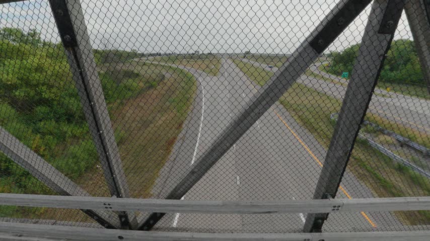 Driving Along the Trail and Crossing an Overpass Above the Highway - POV Shot