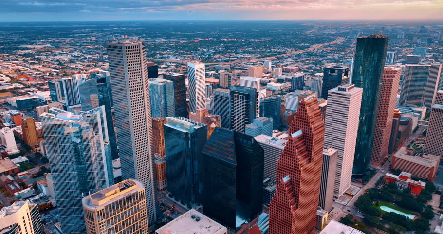 Modern high-rise architecture in the city downtown from drone footage. Flight over the spectacular skyscrapers of Houston, Texas, USA at sunset.