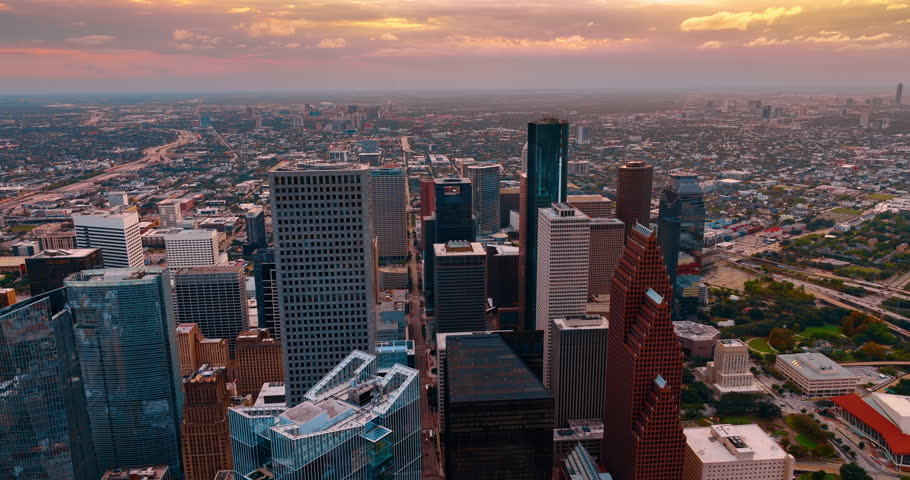 Vast scenic view on modern Houston, Texas, USA at sunset time. Cityscape of a fourth most populous American metropolis from drone.