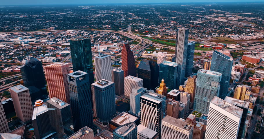 Variegated high-rise panorama of Houston downtown, Texas, USA. Drone footage distancing from city midtown at daytime.