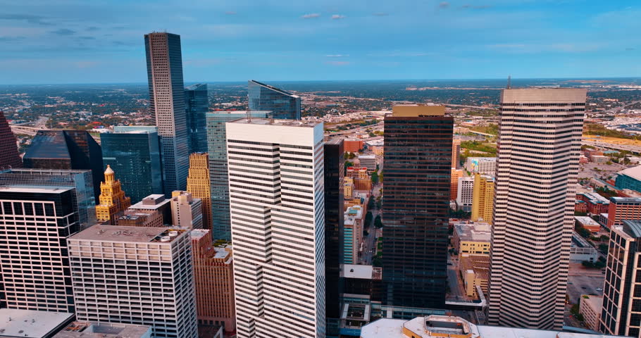 Flight at the tops of high-rises in the diverse downtown of Houston, Texas, USA. Aerial perspective on the city center at daytime.