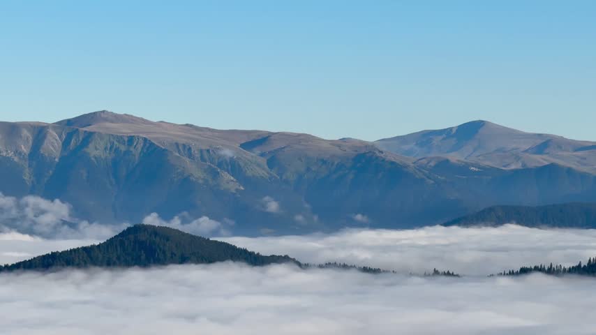 Majestic mountain range landscape with glacial lake and cloudy sky.