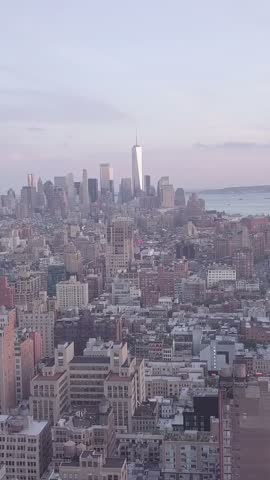 Vertical video: AERIAL: Overlooking Manhattan in Beautiful Purple Sunset Light