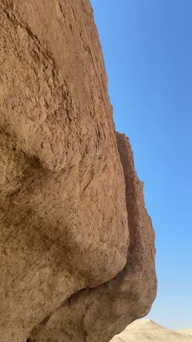 A vast barren desert landscape stretching toward a flat horizon under a clear sky, close up shot