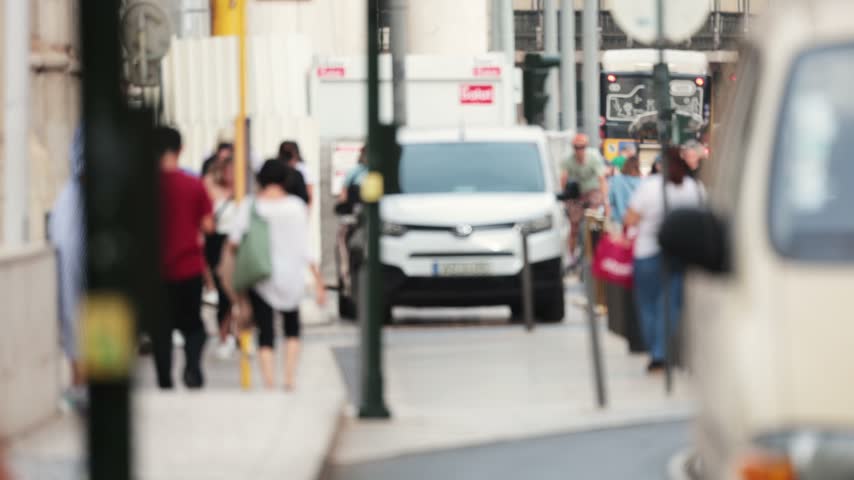 Blurred people and traffic on city street