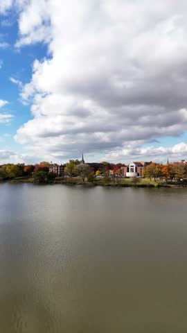 Slow Rise towards Fox River in De Pere Wisconsin.  Fall Colors surround the water with picturesqe Clouds overhead