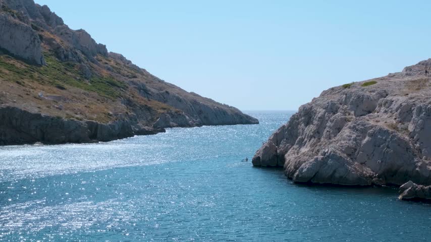 A scenic view of waves rolling against the rugged coastline near Marseille