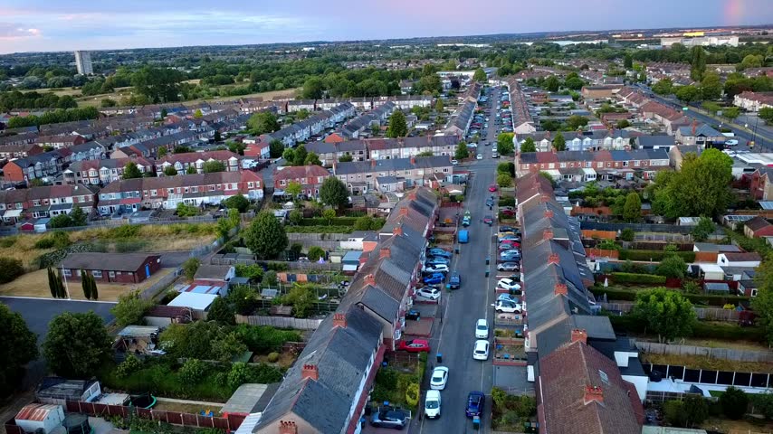 Atmospheric sunset drone footage over the countryside surrounding Ansty Road in Coventry, capturing the changing evening light across fields, roads and green areas.