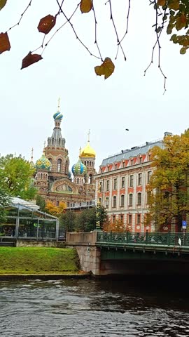 Autumn foliage against the backdrop of the Church of the Savior on Spilled Blood in St. Petersburg, Russia.