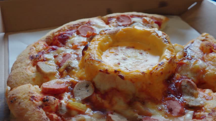 Hand Taking a Slice of Hot Cheesy Sausage Pizza from Delivery Box.