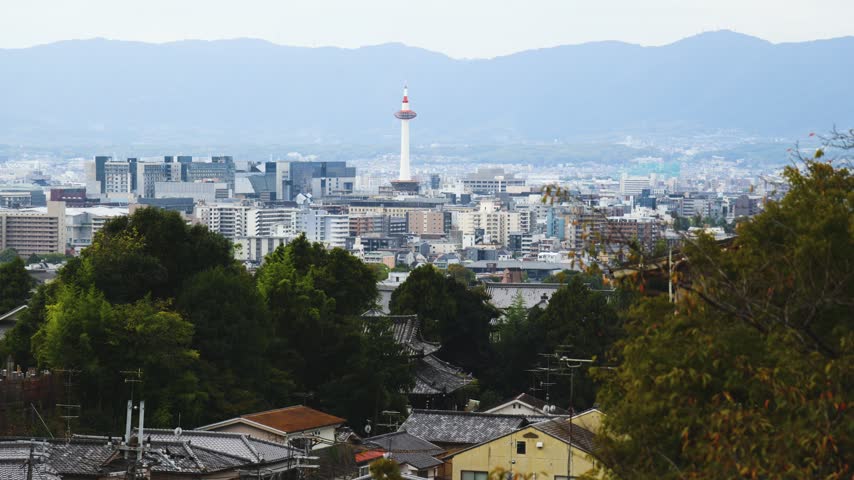 Panoramic view of Kyoto city with Kyoto Tower, traditional rooftops and mountains from Kiyomizu-dera Temple, Higashiyama Ward, Kyoto, Kansai, Honshu Island, Japan