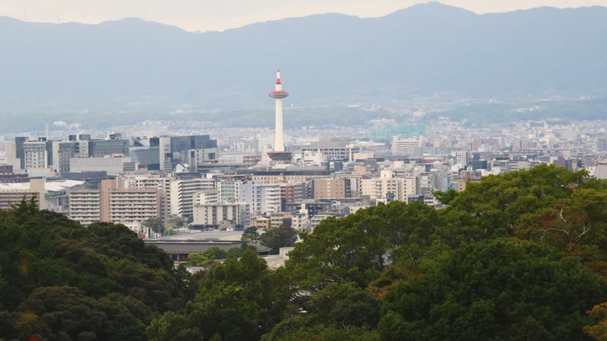Panoramic view of Kyoto city with Kyoto Tower, traditional rooftops and mountains from Kiyomizu-dera Temple, Higashiyama Ward, Kyoto, Kansai, Honshu Island, Japan
