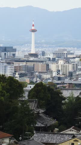 Panoramic view of Kyoto city with Kyoto Tower, traditional rooftops and mountains from Kiyomizu-dera Temple, Higashiyama Ward, Kyoto, Kansai, Honshu Island, Japan