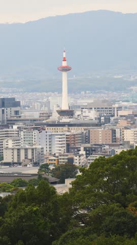 Panoramic view of Kyoto city with Kyoto Tower, traditional rooftops and mountains from Kiyomizu-dera Temple, Higashiyama Ward, Kyoto, Kansai, Honshu Island, Japan