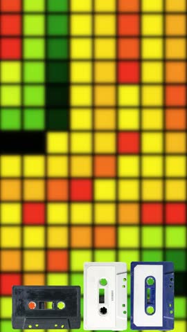 Cassette tapes stack into puzzle blocks over a glowing multicolored pixel grid mosaic. Retro analog aesthetic evokes nostalgia for music and gaming themes.