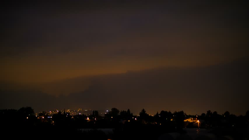 Thunderstorm with Lightning Over a City. Powerful Lightning Flashes Above an Urban Landscape. Bright Lightning Illuminating the City Skyline.