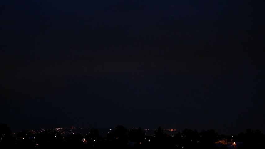 Thunderstorm with Lightning Over a City. Powerful Lightning Flashes Above an Urban Landscape. Bright Lightning Illuminating the City Skyline.