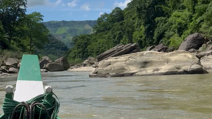 Navigating through the rocky rapids and giant stones of Raja Pathor by wooden tourist boat in the Chittagong Hill Tracts.