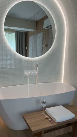 Modern luxury bathroom with freestanding bathtub and illuminated mirror interior
