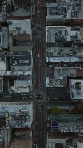 Vertical view of Midtown Manhattan, New York City, street showing yellow cabs and traffic navigating and buildings